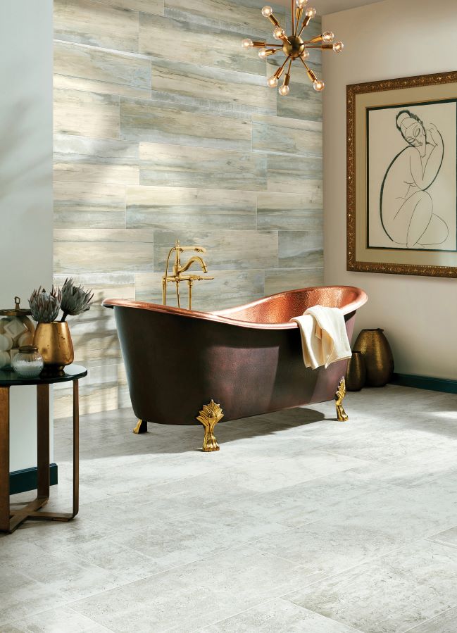 grey tile flooring in a stylish bathroom with a copper tub